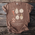 Brown t-shirt with "PROTECTIVE TALISMANS" and various illustrated protective symbols.