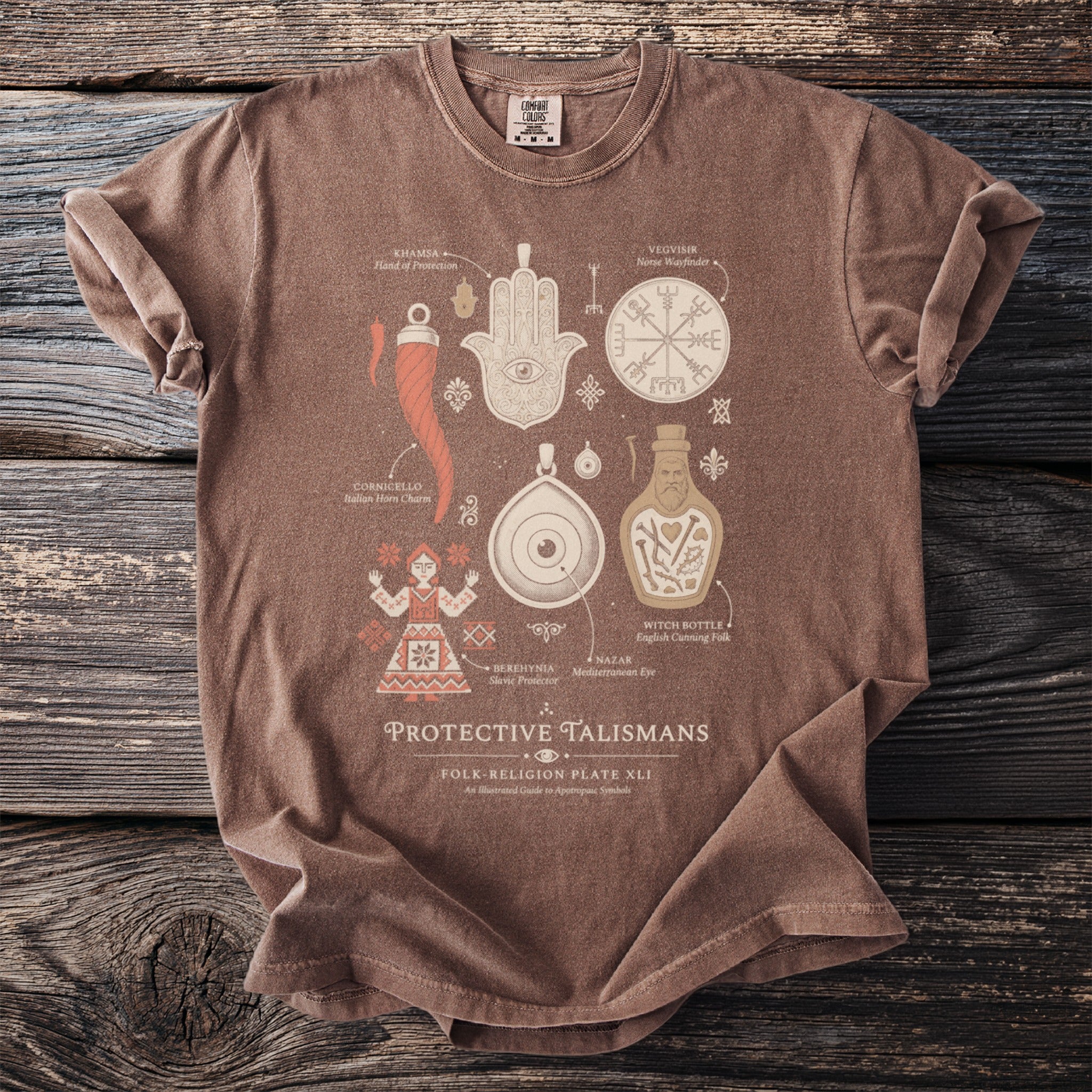 Brown t-shirt with "PROTECTIVE TALISMANS" and various illustrated protective symbols.
