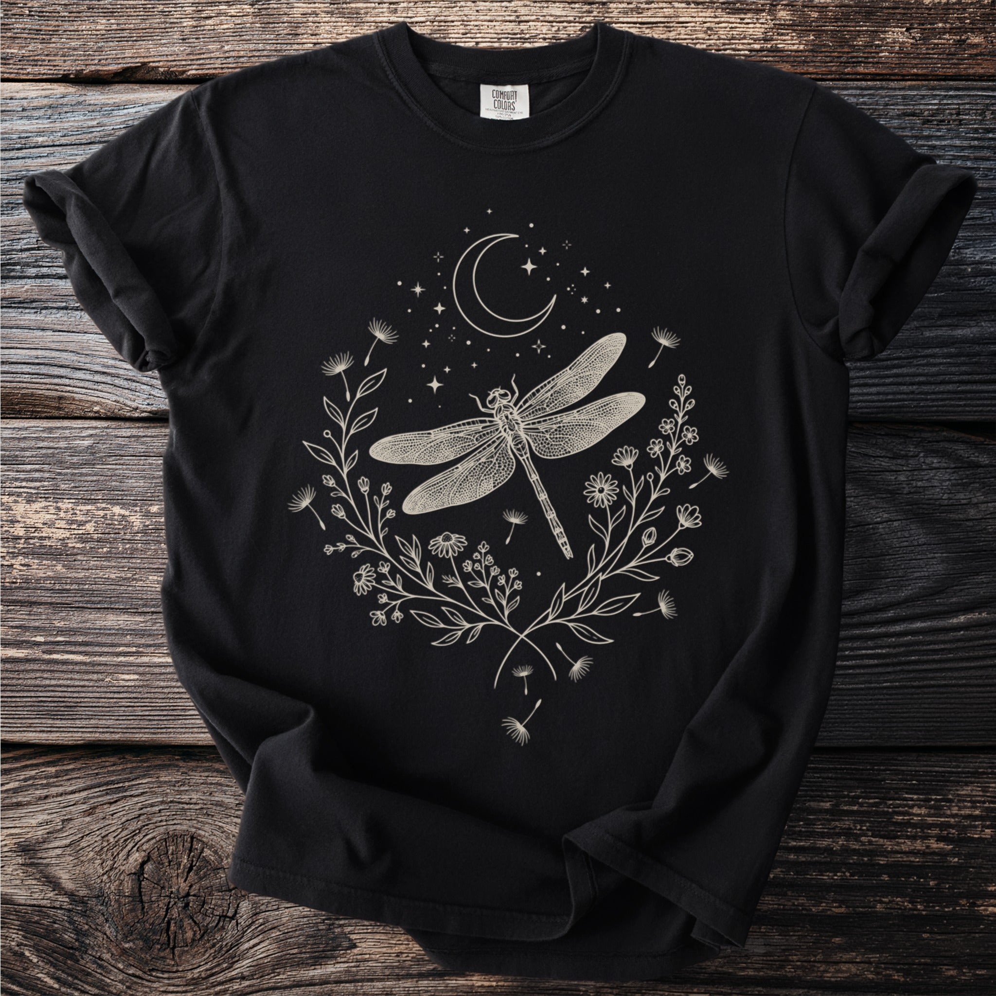 Black t-shirt with cream dragonfly, crescent moon, stars, and floral design.