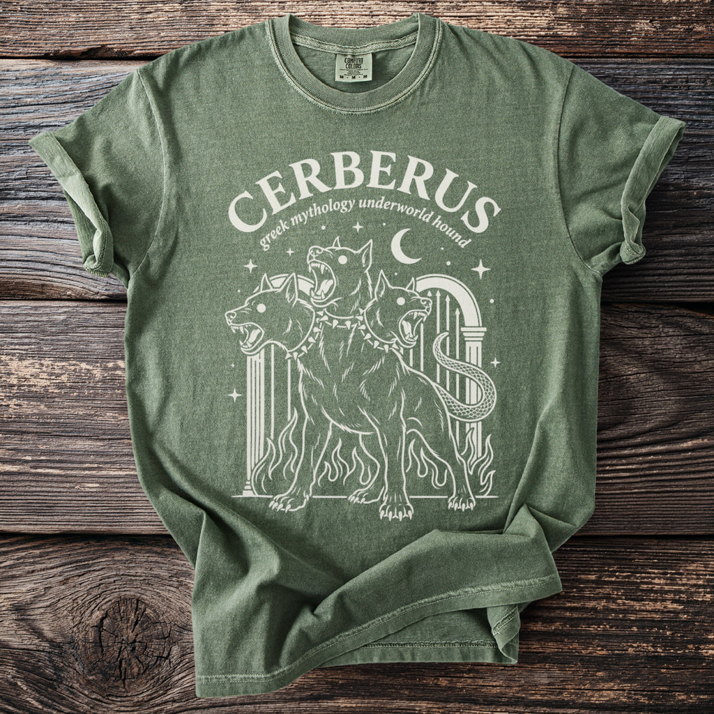 Green t-shirt with white graphic of three-headed Cerberus and text "CERBERUS Greek mythology underworld hound".