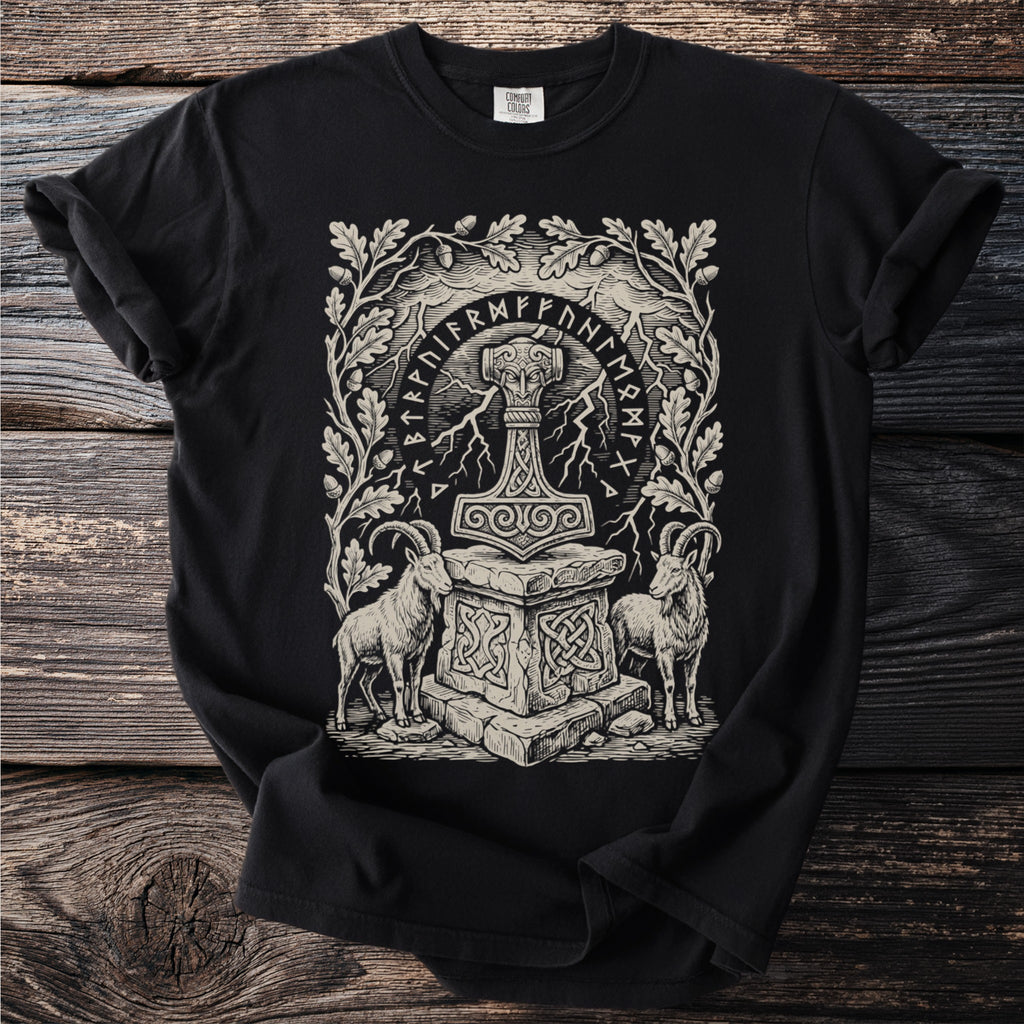 Thor's Hammer, two goats, and oak leaves framed by runes on a black t-shirt.