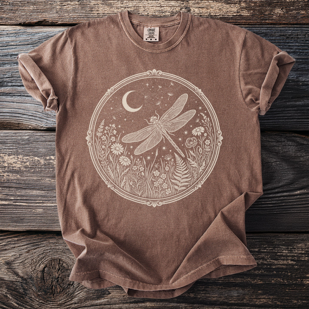 Brown t-shirt with a circular cream graphic of a dragonfly and floral elements.