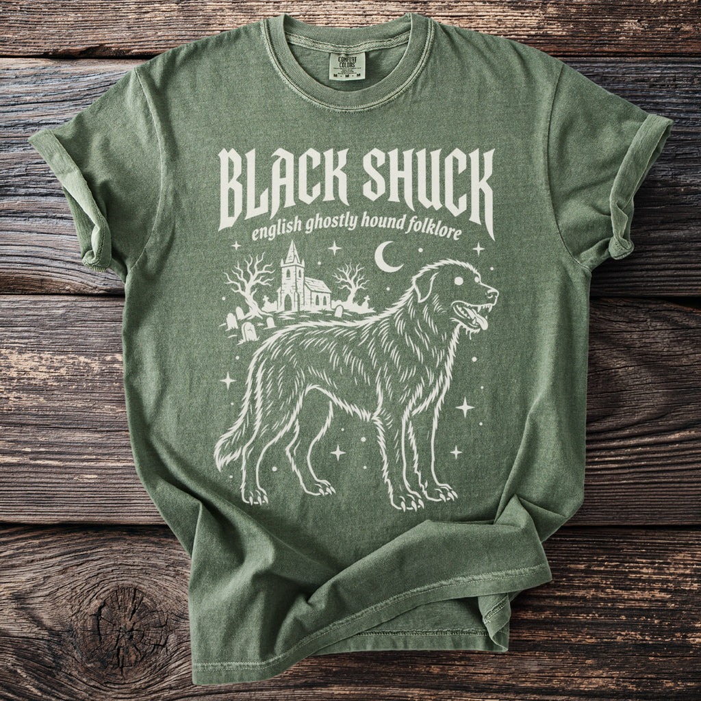 Green t-shirt with "BLACK SHUCK english ghostly hound folklore" and dog illustration.