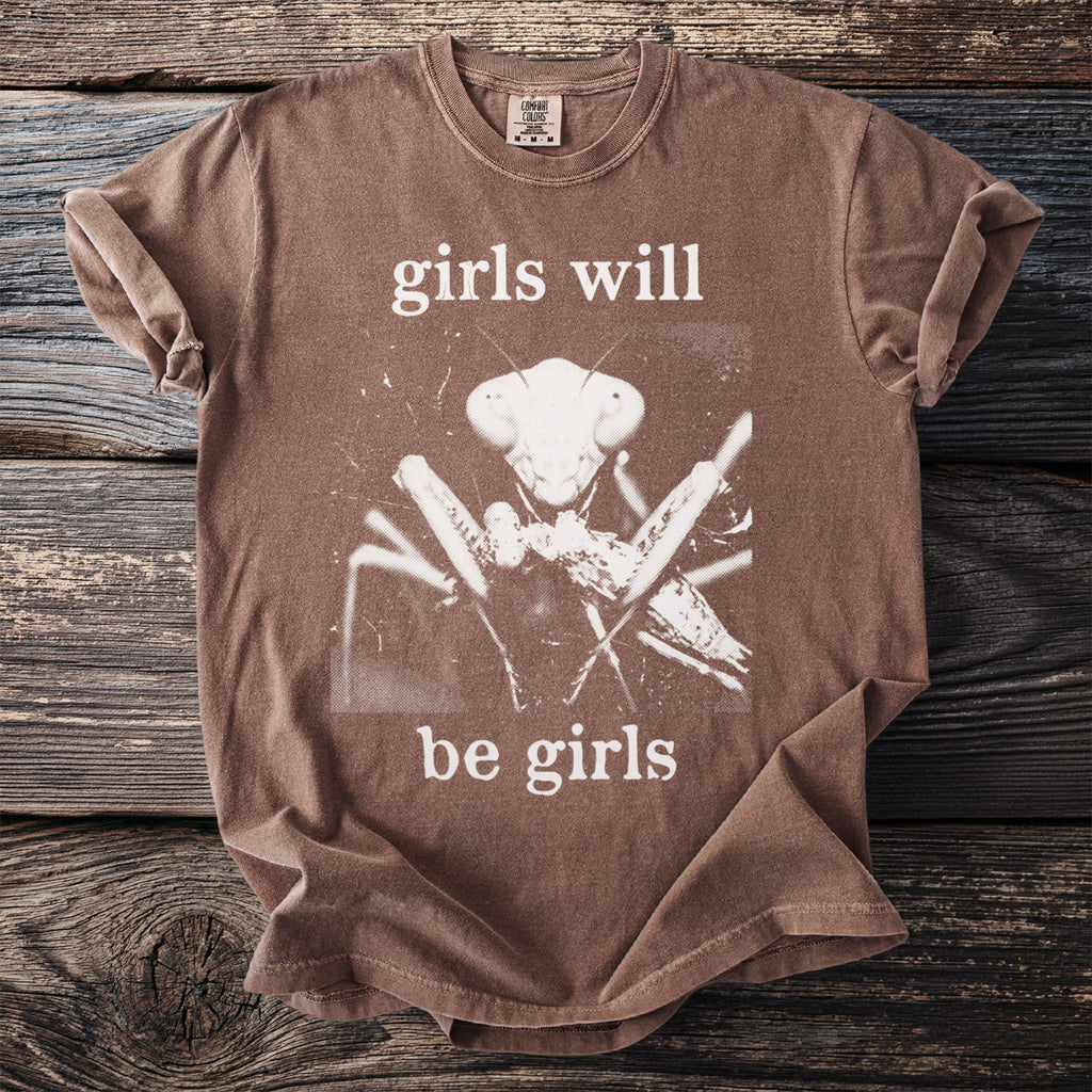 Brown t-shirt with a white praying mantis graphic and "girls will be girls" text.