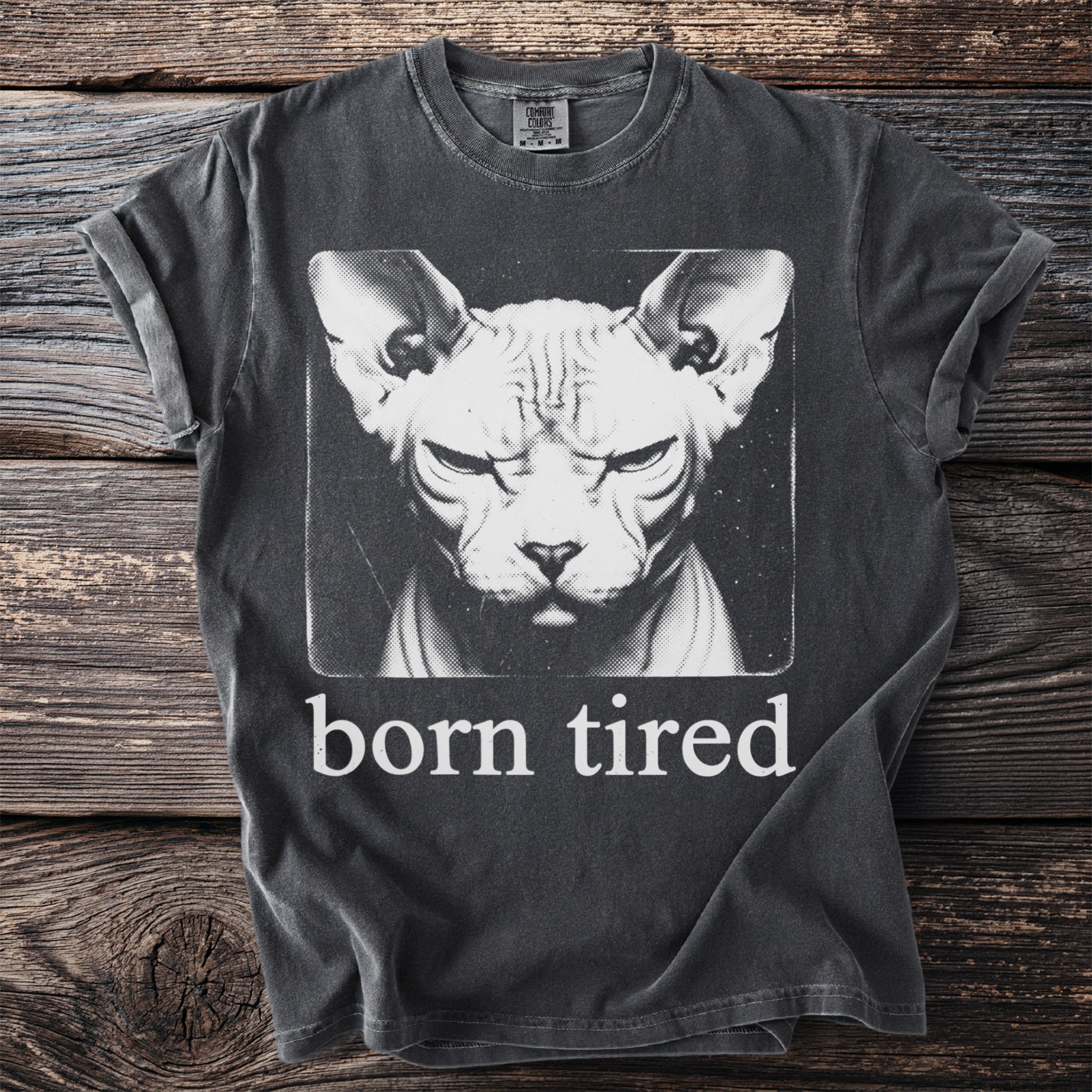 Dark grey t-shirt with a Sphynx cat graphic and the text "born tired".