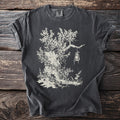 Dark t-shirt with a cream illustration of a gnarled tree with a lantern hanging from a branch.