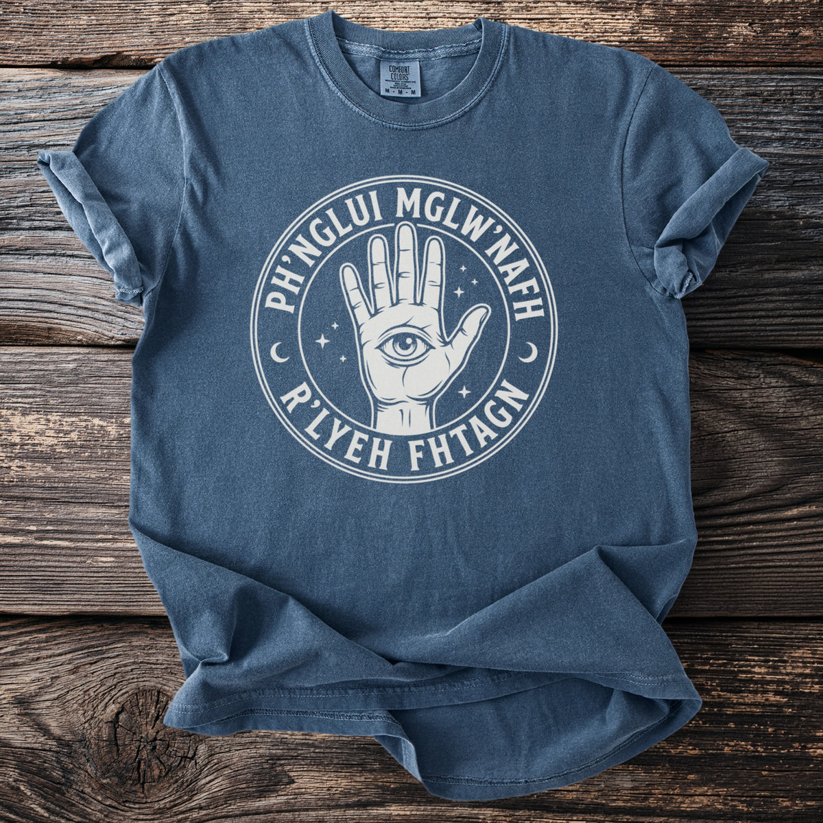 Blue t-shirt with a white circular design featuring an open palm with an eye and text.
