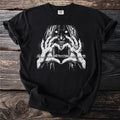 Black t-shirt with a black and white graphic of a monstrous figure with glowing eyes forming a heart.