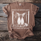 Brown t-shirt with national parks theme artwork: deer, moth, ghosts, and toad.