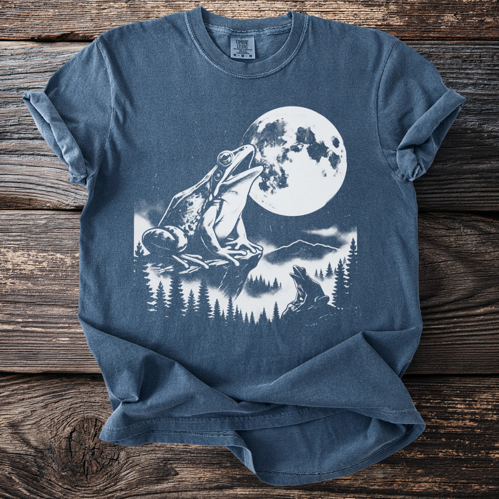 Frogs sit on rocks under a large moon and pine trees.