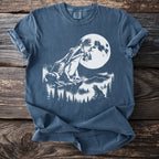 Frogs sit on rocks under a large moon and pine trees.