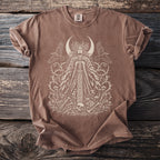 Brown t-shirt with a white graphic of a woman, crescent moon, ravens, and floral elements.