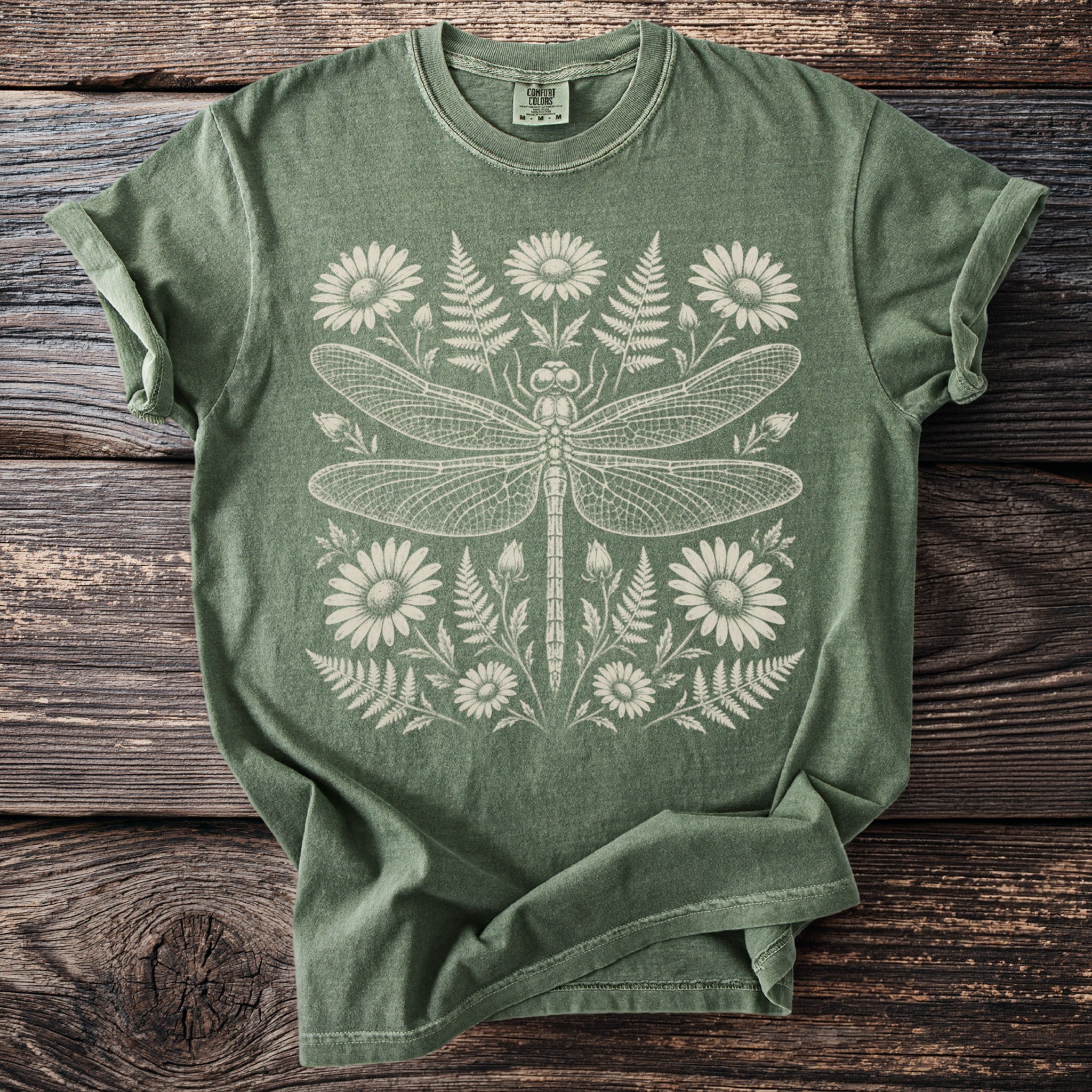 Green t-shirt with cream dragonfly and floral design.