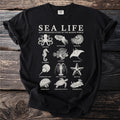 Black t-shirt with "Sea Life" and illustrations of marine animals.