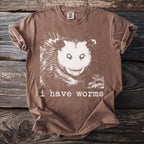 Brown t-shirt with white opossum graphic and text "i have worms".