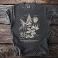 T-shirt with botanical illustrations and text: The Understory Cabinet.