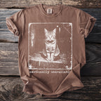 Brown t-shirt with white graphic of a cat and text "emotionally unavailable".