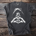 T-shirt with a hooded figure with piercing eyes and hands forming a heart with coins.