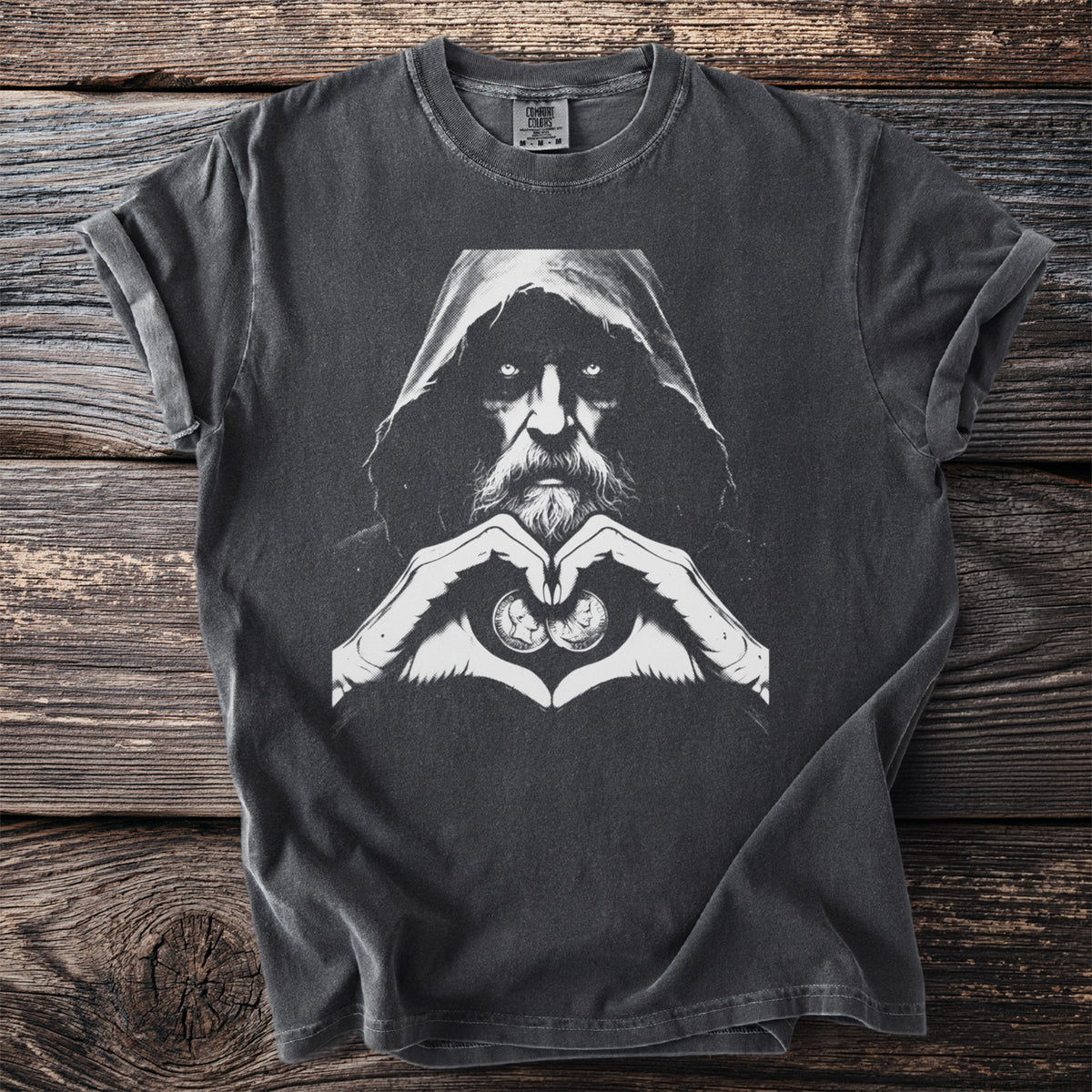T-shirt with a hooded figure with piercing eyes and hands forming a heart with coins.
