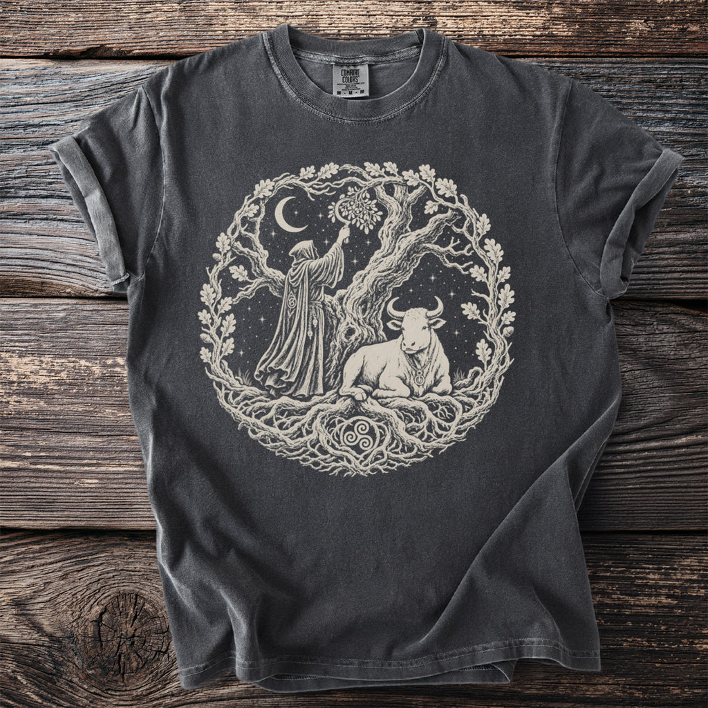 T-shirt with a circular graphic of a robed figure, bull, and tree under a moon.