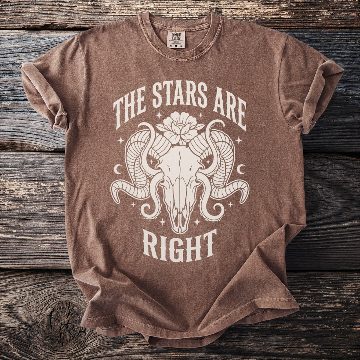 Brown t-shirt with a ram skull graphic and text "THE STARS ARE RIGHT".