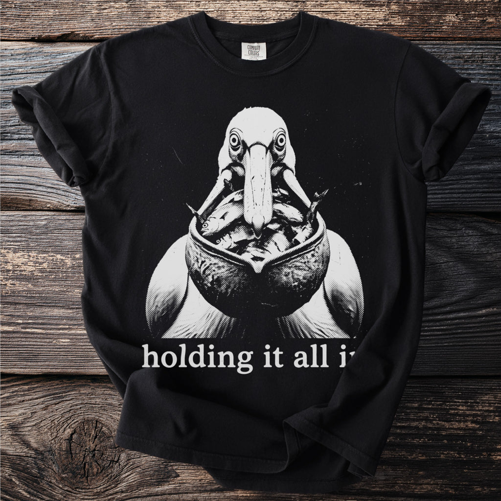 Black t-shirt with a graphic of a pelican holding fish in its beak and text.