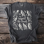 Dark grey t-shirt with an illustration of birds and the text "respect the locals".