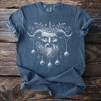 Blue shirt with white illustration of a horned demon with a wreath and hanging ornaments.