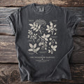Dark grey t-shirt with illustrated plants and text: "The Hedgerow Harvest".