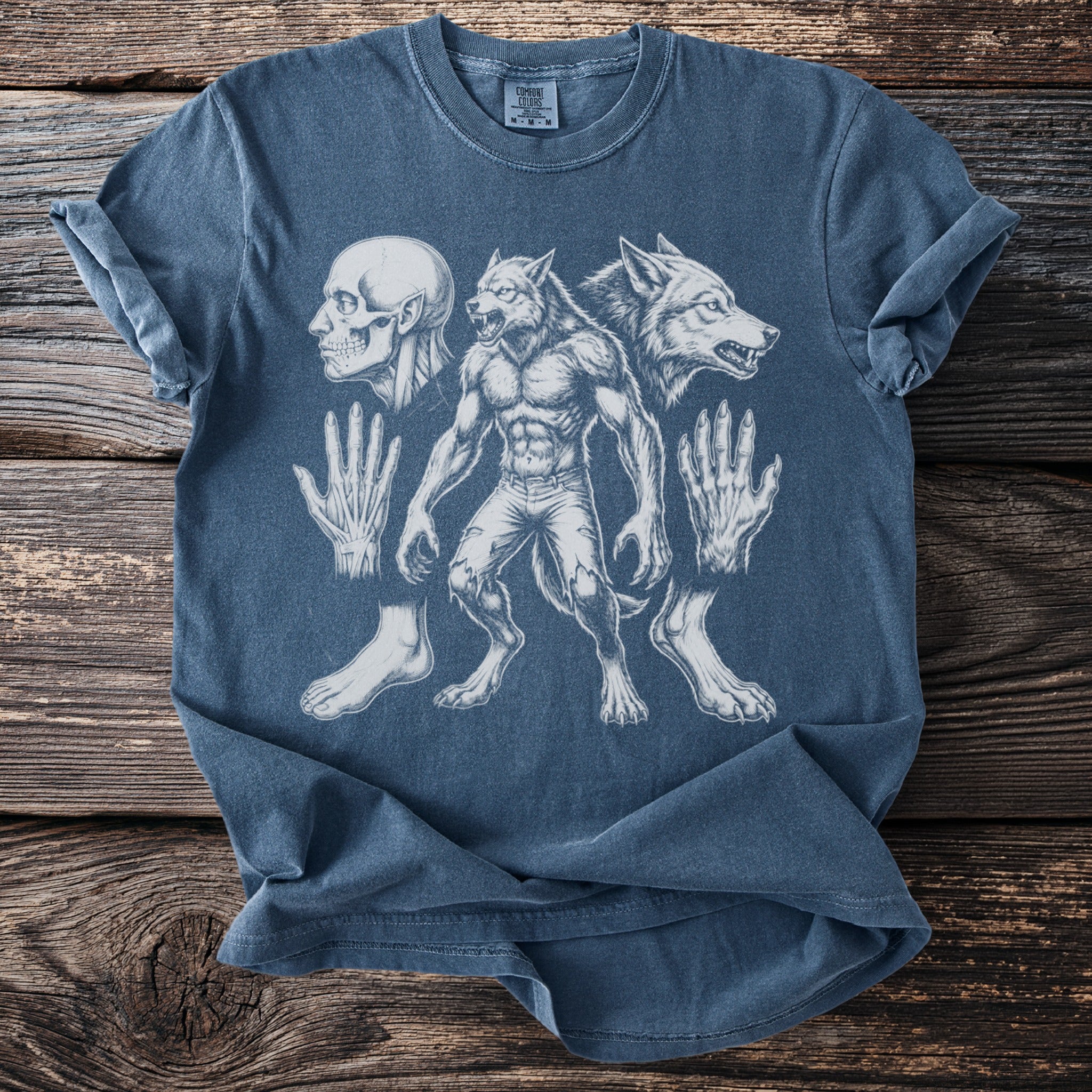 Blue t-shirt with drawing of a werewolf, wolf head, skull, hands, and feet.