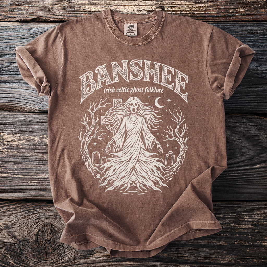 Brown t-shirt with white text and graphic of a Banshee in Irish Celtic folklore.