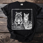Black t-shirt with illustration of raccoon with drink and cat smoking a cigarette.