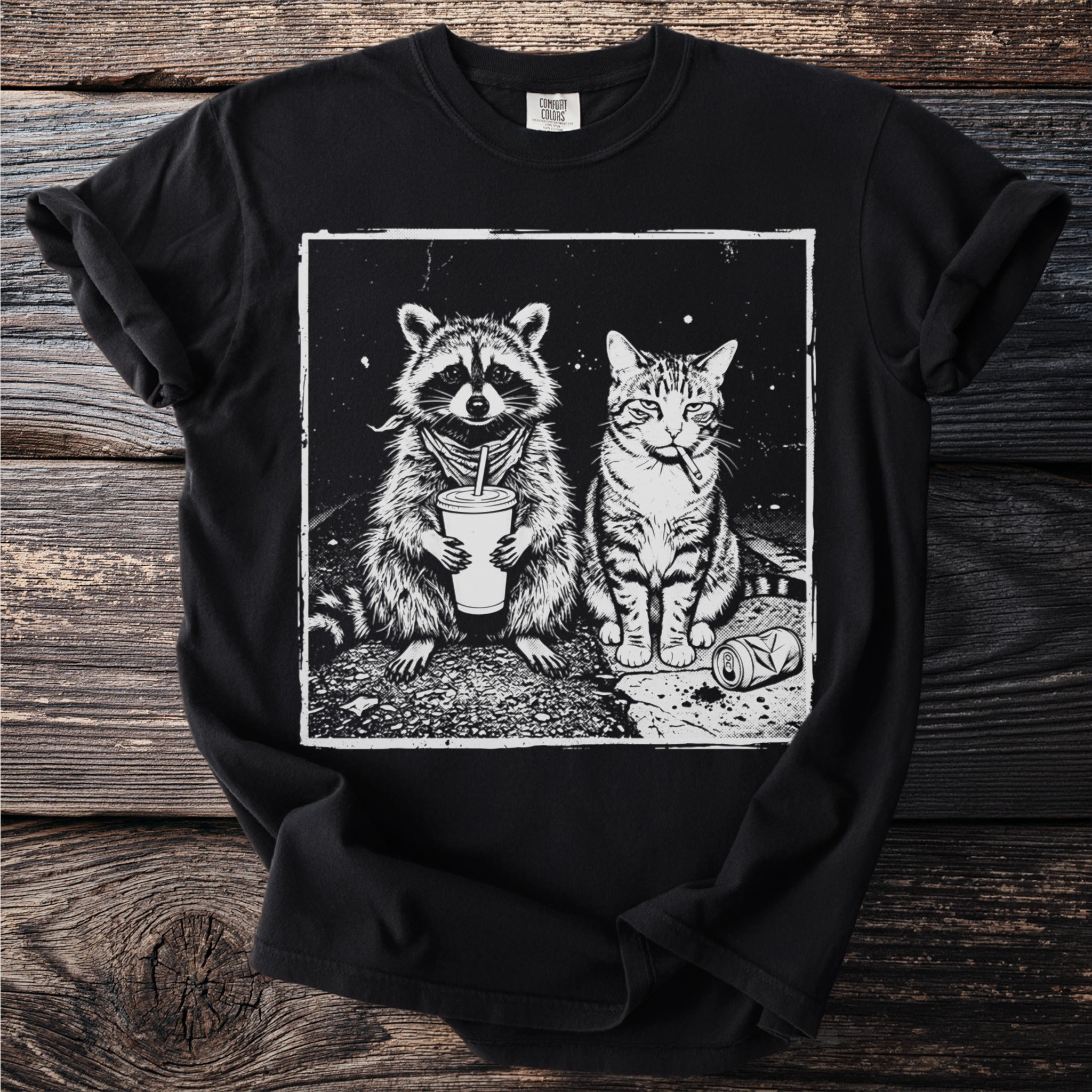 Black t-shirt with illustration of raccoon with drink and cat smoking a cigarette.