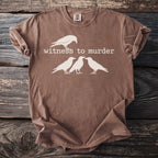 Brown t-shirt with white graphic of four ravens and the text "witness to murder".
