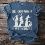 Blue t-shirt with white graphic of three witches, text "God forbid women have hobbies".