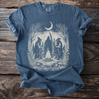 Blue t-shirt with gothic artwork of hooded figures around a campfire under a crescent moon.