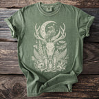 Green t-shirt with occult-themed moon, raven, antlers, and skull graphic.