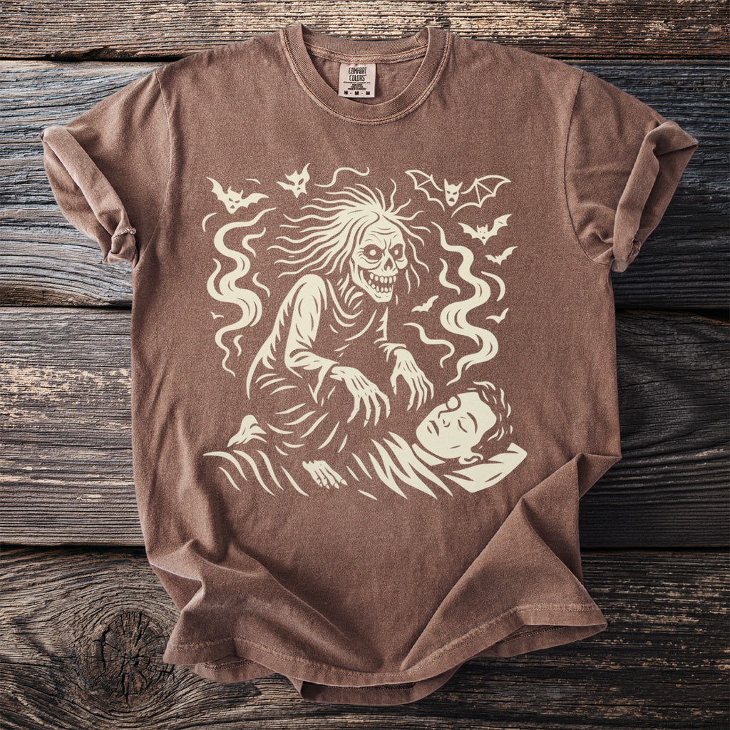 Brown t-shirt with a cream graphic of a decaying figure looming over a sleeping person.