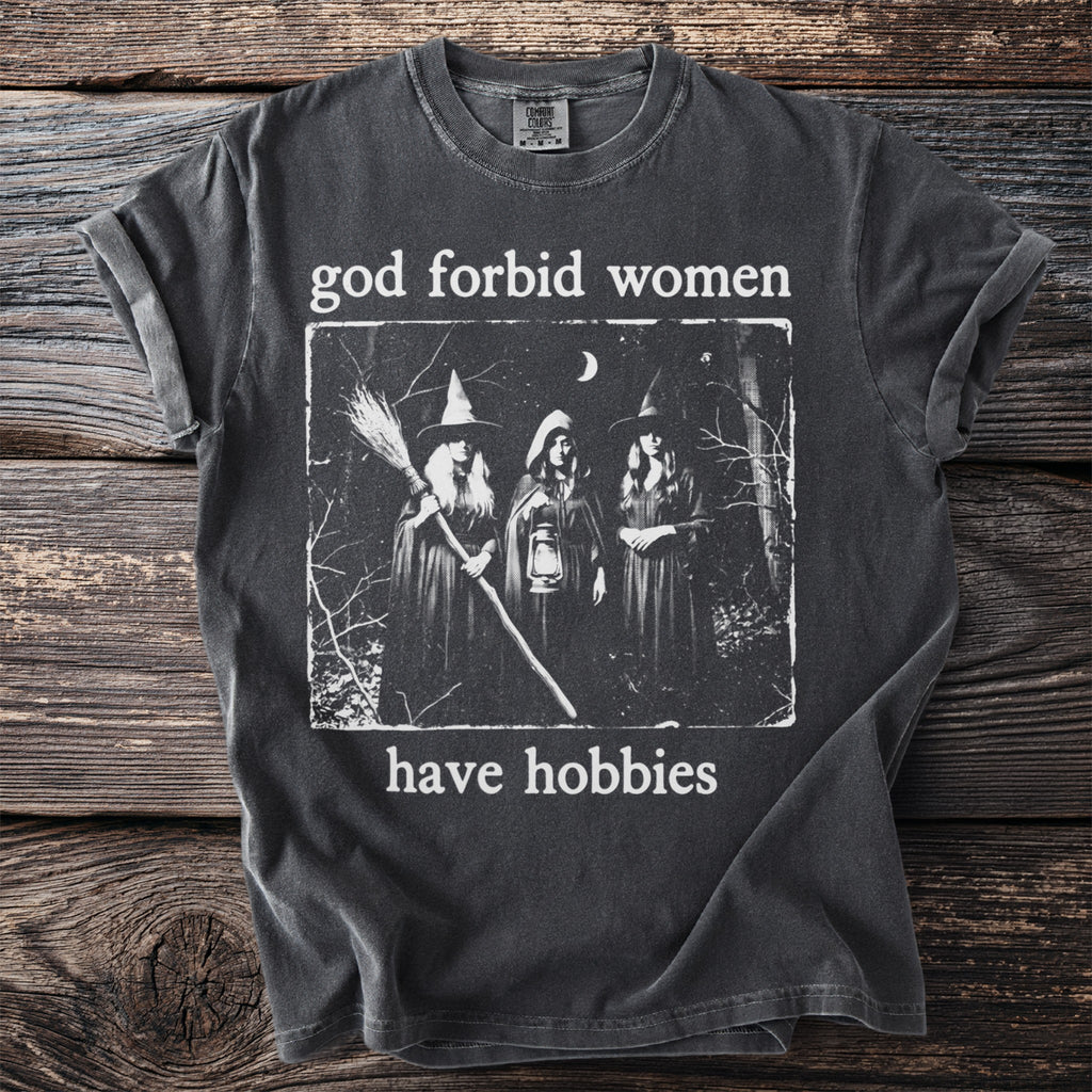 T-shirt with a graphic of three witches and the text "God forbid women have hobbies."