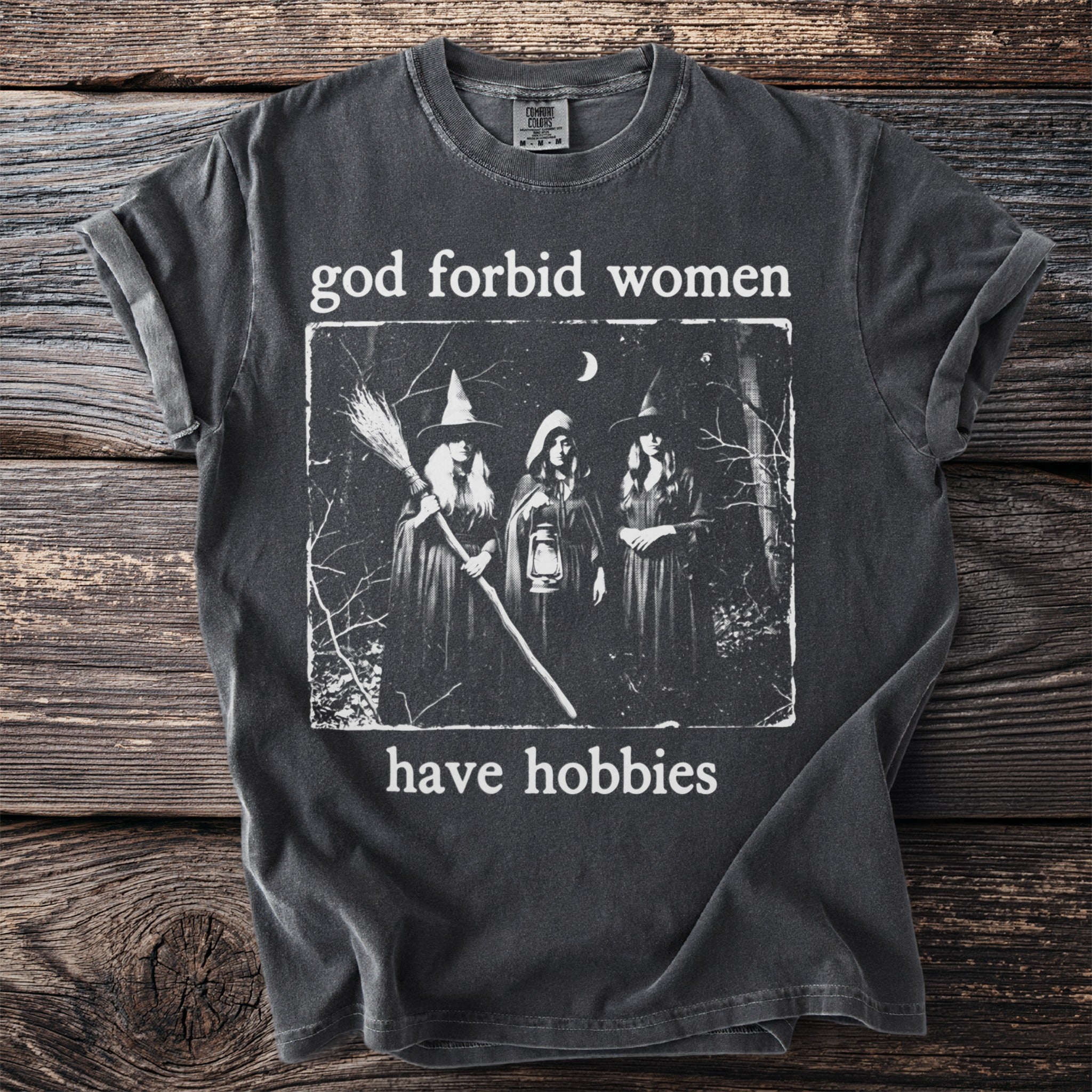 T-shirt with a graphic of three witches and the text "God forbid women have hobbies."