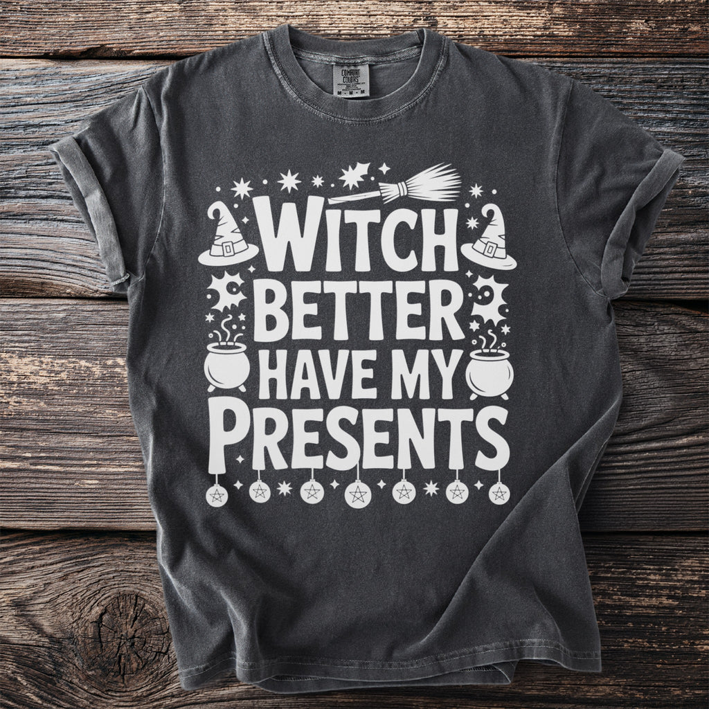 Dark gray t-shirt with white text and Halloween graphics reading "Witch Better Have My Presents".