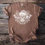 Brown t-shirt with white sugar skull, bat wings, and holiday holly design.