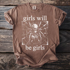 Brown t-shirt with white text "girls will be girls" and a spider graphic.