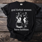 Black t-shirt with "God forbid women have hobbies" and witch graphic.
