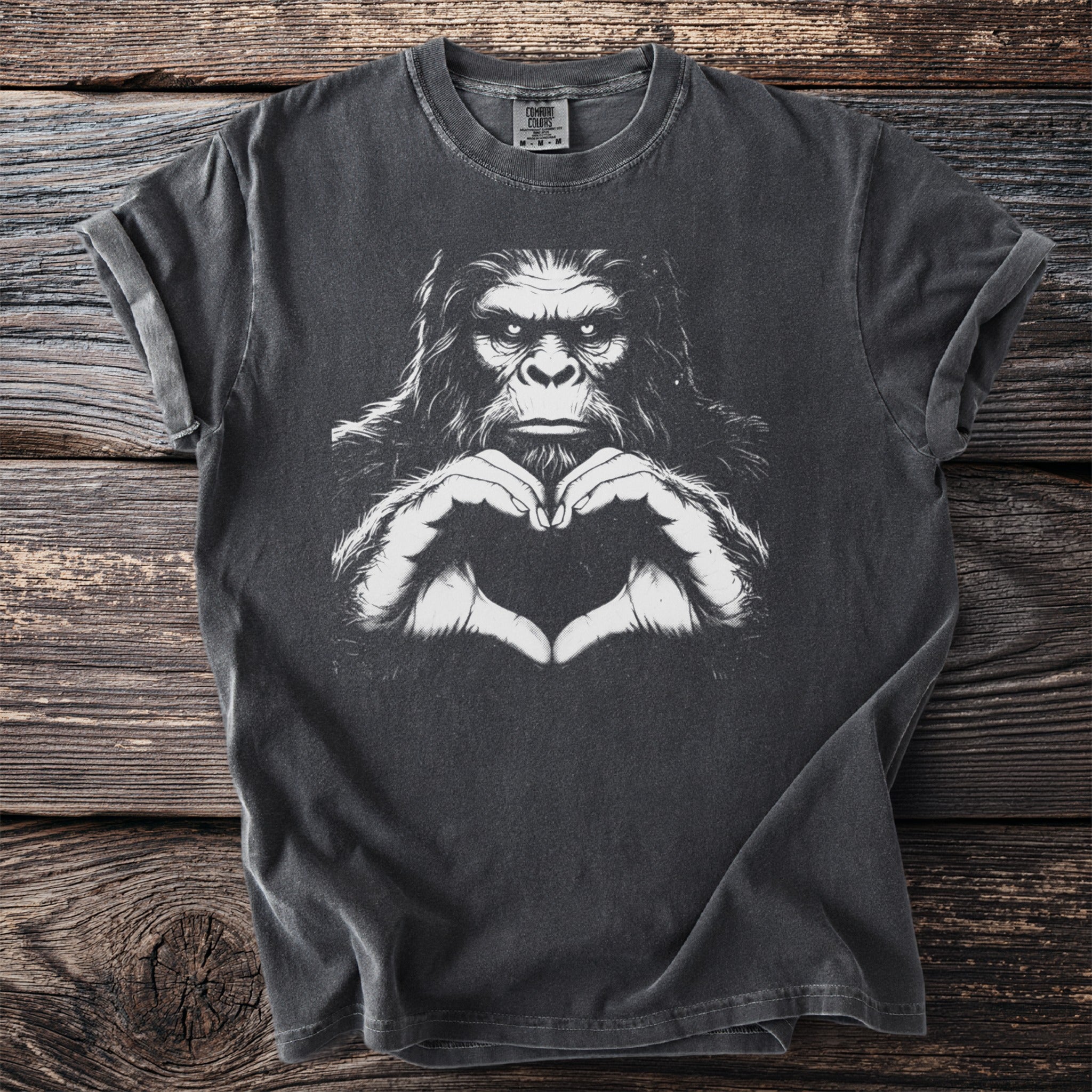 Gray t-shirt with white graphic of a gorilla making a heart shape with its hands.