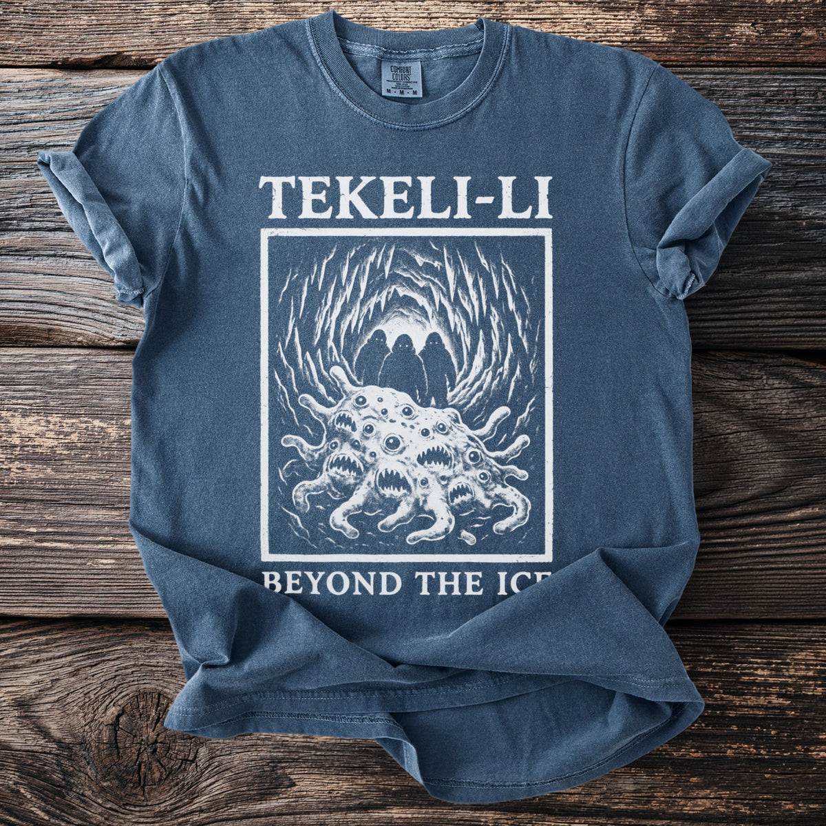 Blue t-shirt with "TEKELI-LI BEYOND THE ICE" and a creature with many eyes.