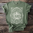 Green t-shirt with "All Plants Are Edible Some Only Once" text and skull design.
