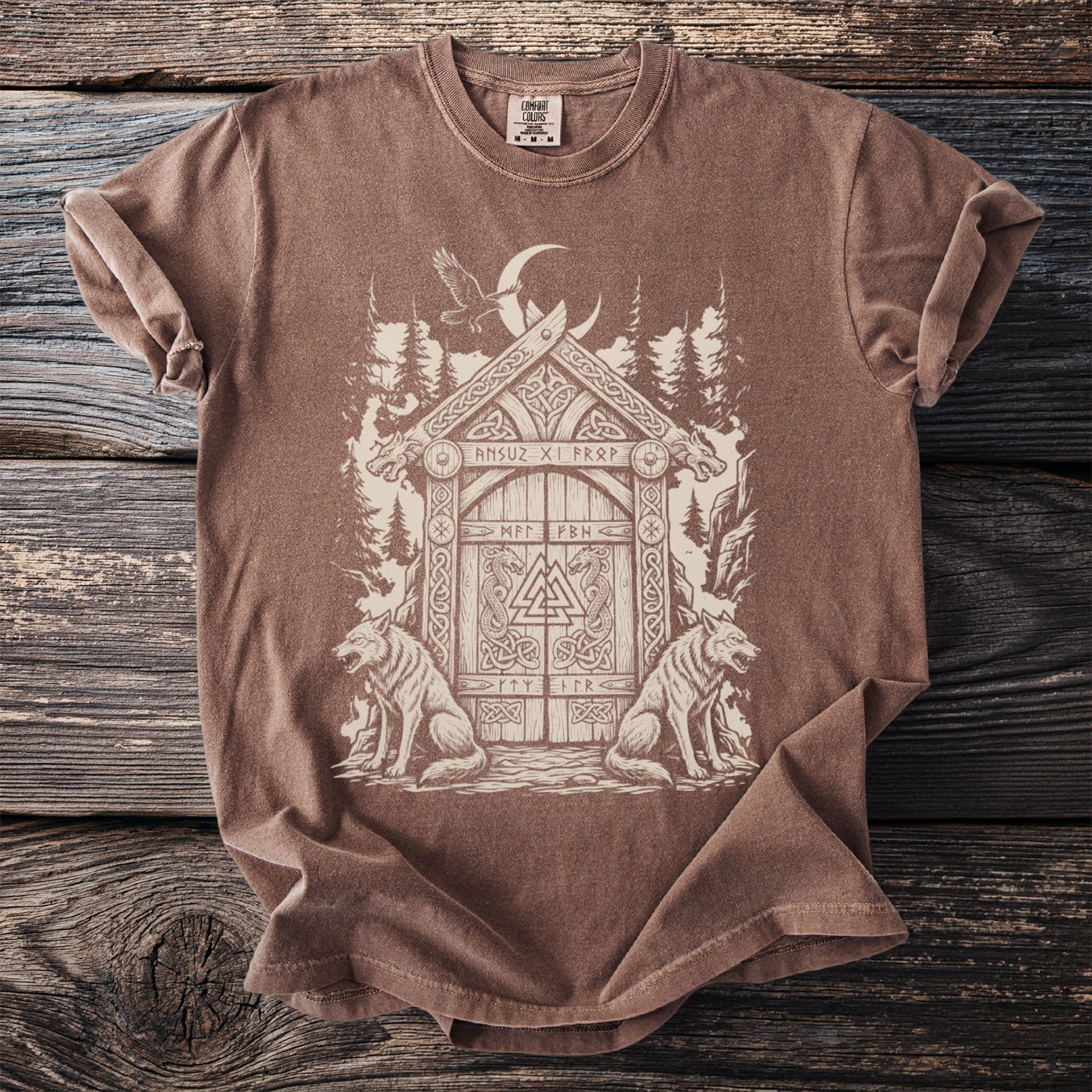 Brown t-shirt with a Norse-inspired graphic of a doorway between two wolves.