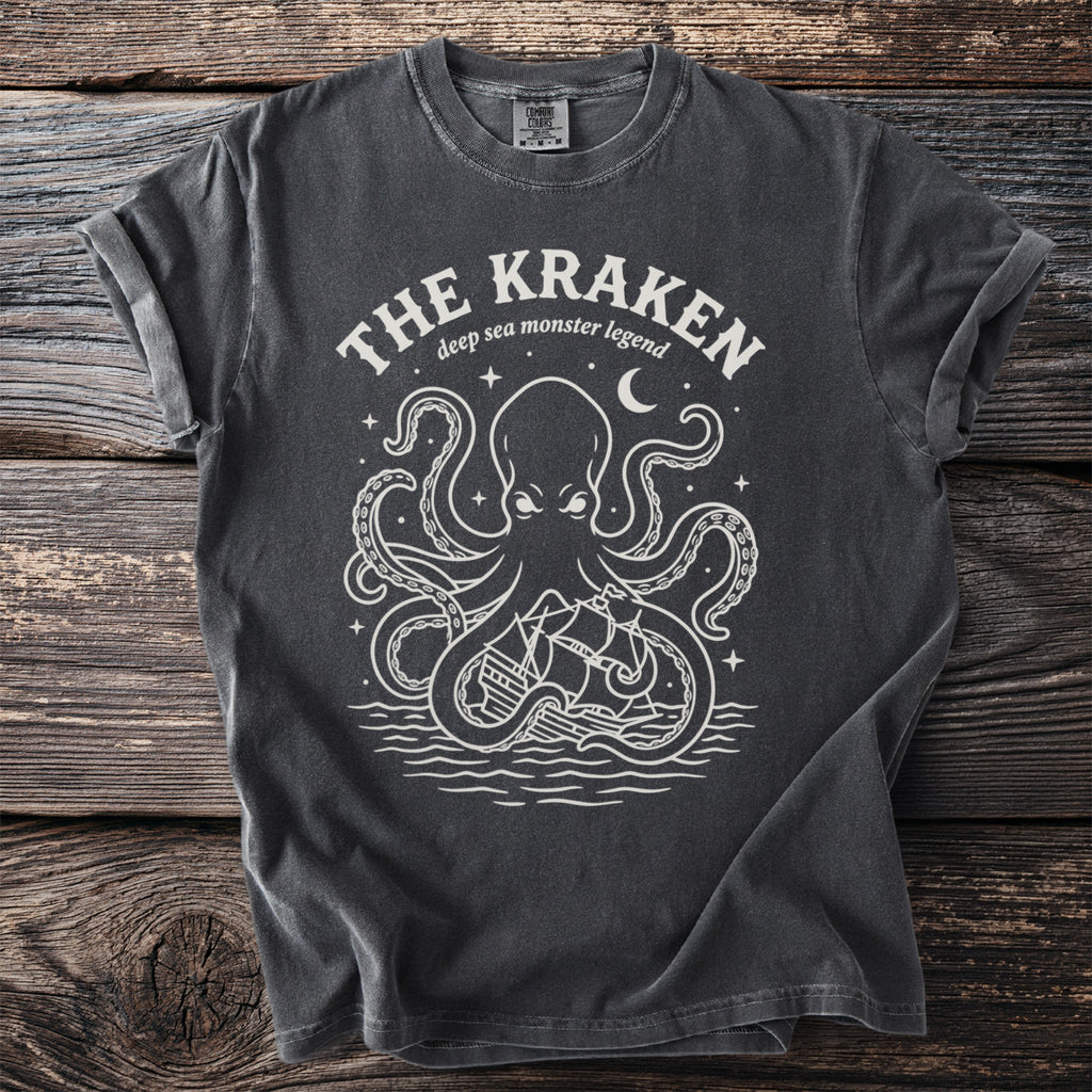 Dark charcoal t-shirt with white Kraken and ship graphic and text.