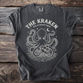 Dark charcoal t-shirt with white Kraken and ship graphic and text.